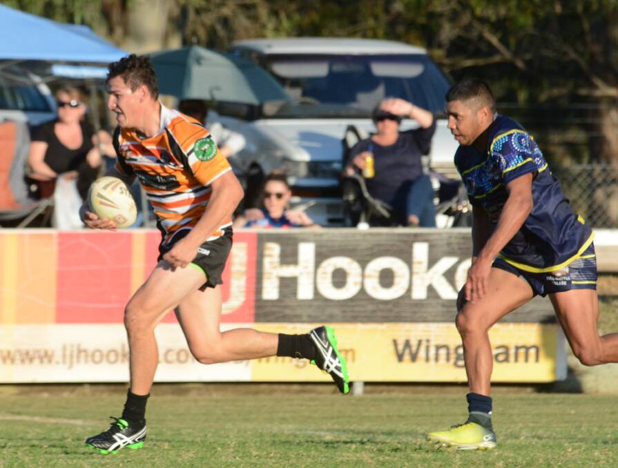Wingham centre Tim Bridge clears out from the Macleay Valley defence during the Group Three Rugby League game at Wingham. The Tigers won 30-26.