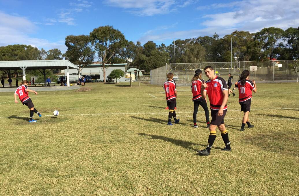 Warming up: Members of the Great Lakes College football team warm up before their knock-out match against Epping Boys High School earlier this week.
