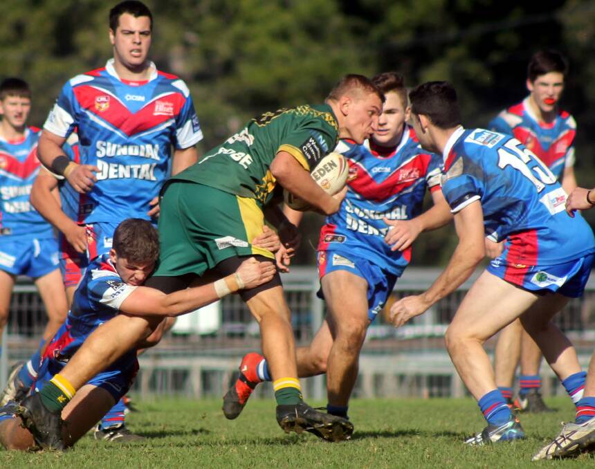 Forster-Tuncurry Hawks Sam Whitbread runs into the Wauchope defence during Saturdays under 18s clash. 