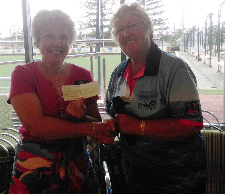 Judy McLaughlin (right) presents a $1800 cheque to Great Lakes Hospice representative, Roz Dreise.