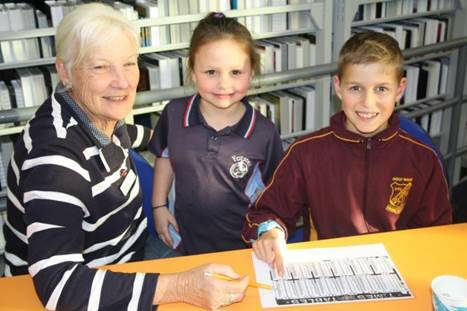 Homework Help Tutor, Lesley Guiney working with Shaneika Wright and Nash Bowen at Forster Library