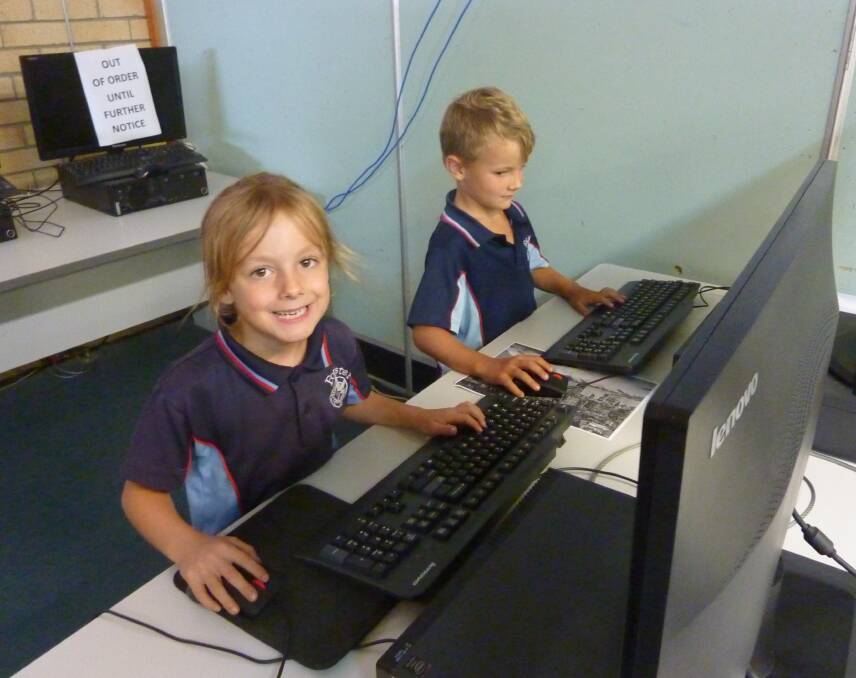 Gracie Pollock-Digges and Archie Connors making use of technology using the bank of computers available in the library.