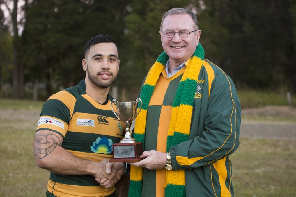 Dolphins' captain, Matt Nuku receiving the Hobbs Hessing cup from Member for Myall Lakes, Stephen Bromhead.