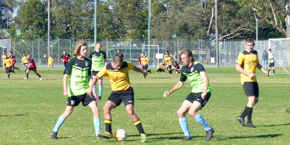 Reserves: Tuncurry Forster's Rod Yanez and Adam Christensen combine against Jayden Carmody and Brock Gutherson from Wallis Lake played in blustery conditions on the weekend.
