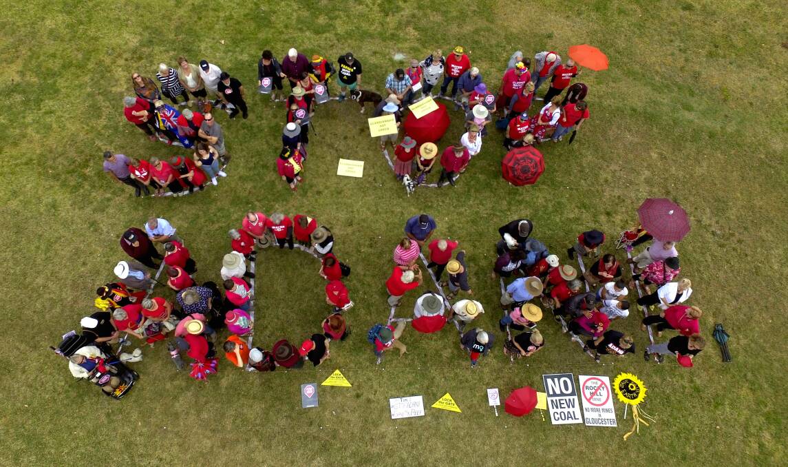 Around 100 people from Gloucester, Forster and Taree gathered at Billabong Park, Gloucester to create the sign.