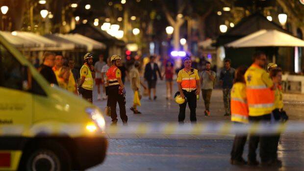 Emergency workers stand on a blocked street in Barcelona. Photo: AP