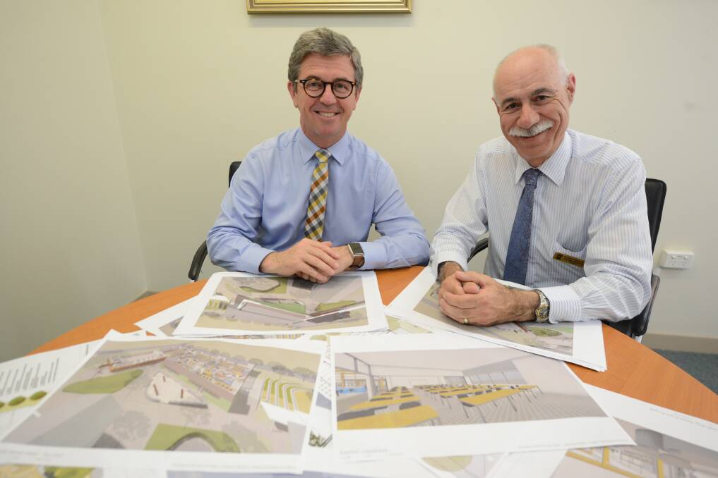 Looking at plans: Member for Lyne Dr David Gillespie and St Clare’s High School principal, Peter Nicholson look over the artist's impression of the new $4.89-million building for the school. 
