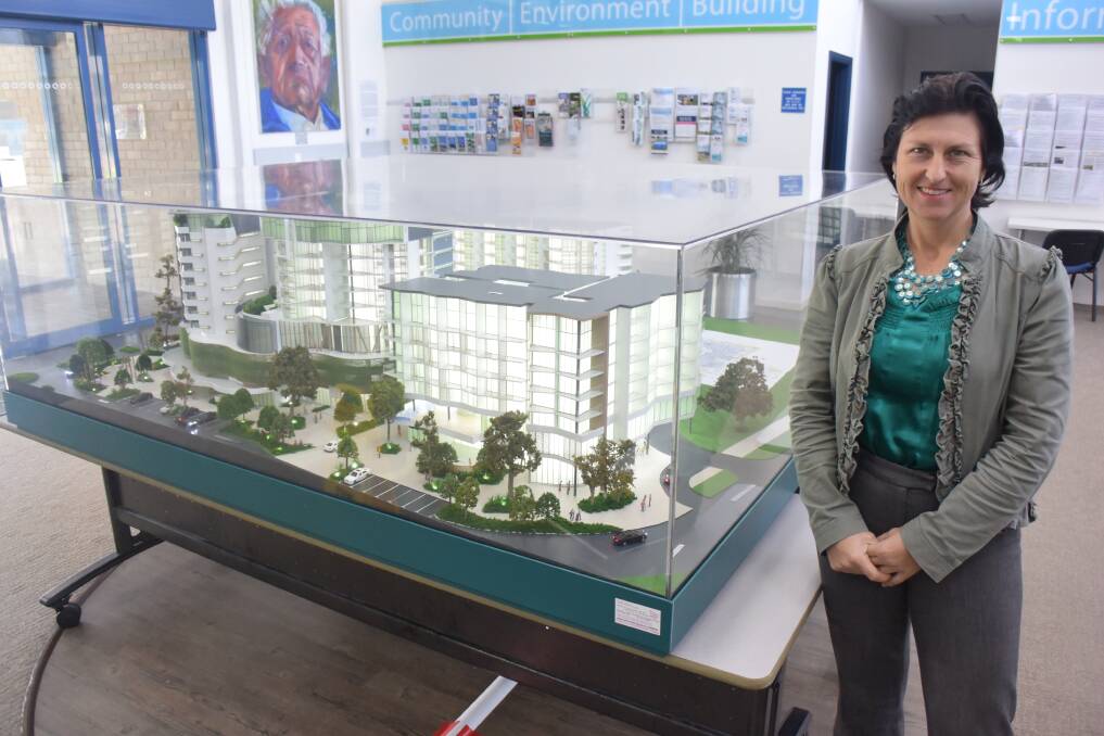 First-hand look: MidCoast Council commercial services co-ordinator Allison Anthony and the model of the Forster civic precinct at the Forster Administration Centre. 