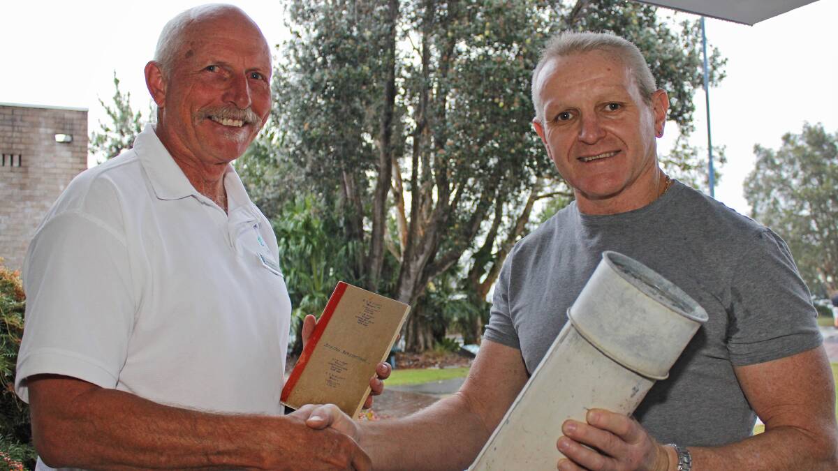 The weather was befittingly wet when Trevyln's son Gordon Elliott handed over his father's rainfall gauge and records to MidCoast Council's Ron Hartley.