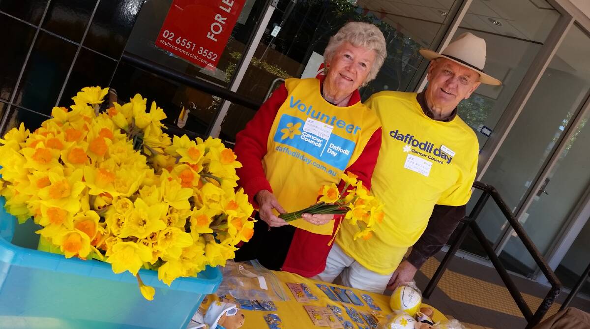 Volunteers Alan and Carolyn Sheppard man the Wharf Street Daffodil Day stall on Friday on behalf of Quota. The charity has hosted the event for more than 10 years.