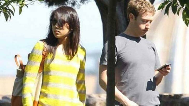 Mark Zuckerburg can't resist checking his phone while out with his wife Priscilla Chan Photo: StopPhubbing.com