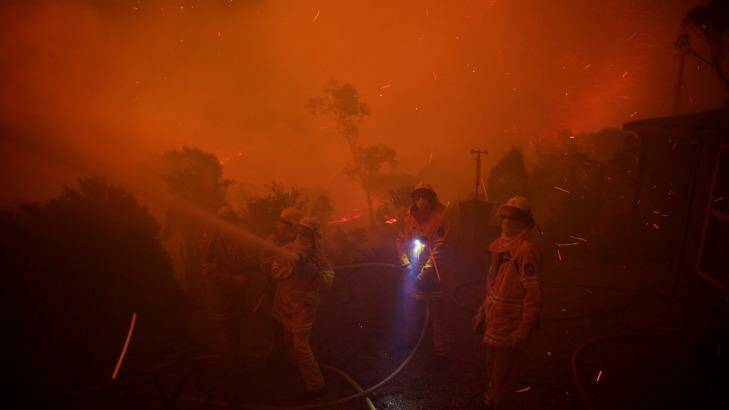 NSW Rural Fire Service crews prepare for impact on homes in Coronation Parade. Photo: Wolter Peeters
