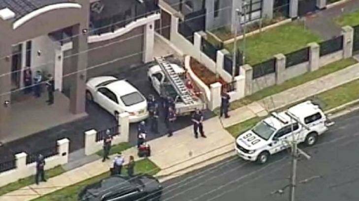 A house in Lockwood Street, Merrylands, was one of two raided by police in Sydney's west. Photo: Channel Nine