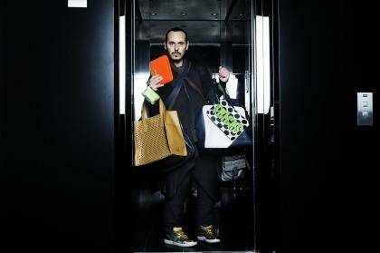 Boys keep swinging: Fashion stylist Fernando Barraza with a selection of man bags. Photo: Nic Walker