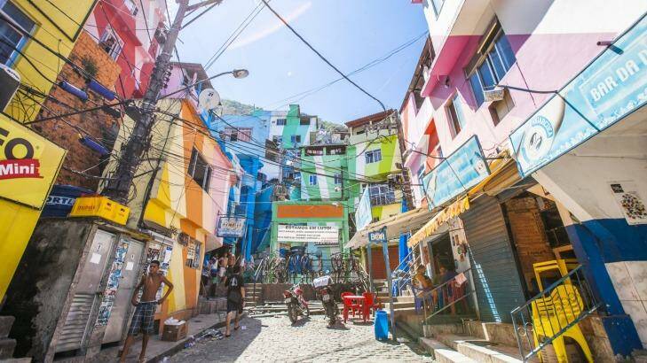 Everyday life in Santa Marta favela, town square named Praca Cantao surrounded by colourful buildings. Photo: iStock