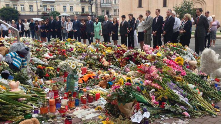 More than 30 embassy staff walked in a solemn line to stand in front of the field of flowers. Photo: Nick Miller