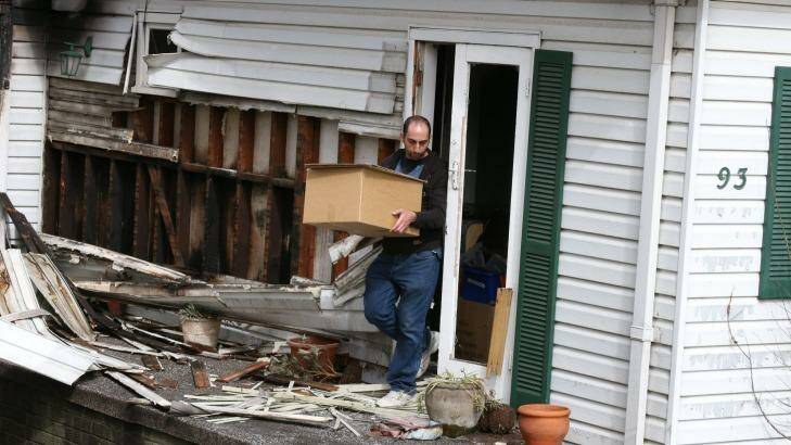 Mr Haddad removes items from the destroyed home. Photo: Peter Rae
