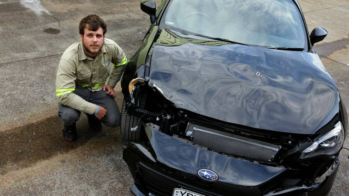 LUCKY ESCAPE: Timothy Larson with his car that was involved in the collision with the deer.  Picture: Jonathan Carroll