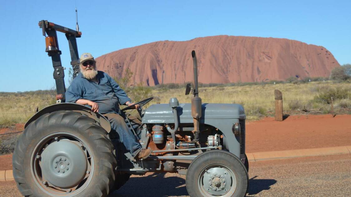 Maiden Gully man Bob Wilson takes time out from his 2500-kilometre journey from Western Australia to Alice Springs in his 1956 Harry Ferguson tractor to take in the iconic Uluru.