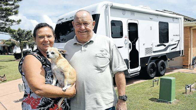 Tuncurry residents, Bev (holding Lilly) and Peter Sadler are confused by fluctuating petrol prices from town to town.