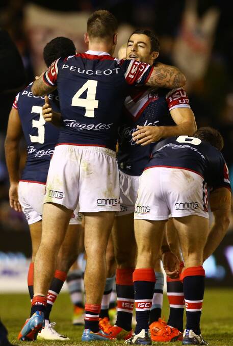 Shaun Kenny-Dowall and Anthony Minichiello of the Roosters embrace after the round seven NRL match between the Cronulla-Sutherland Sharks and the Sydney Roosters at Remondis Stadium on April 19, 2014 in Sydney, Australia. Photo: Mark Nolan/Getty Images.
