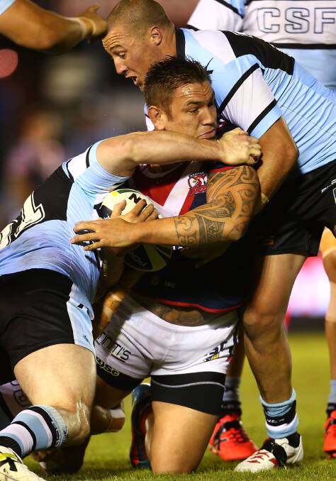  Jared Waera-Hargreaves of the Roosters is tackled during seven NRL match between the Cronulla-Sutherland Sharks and the Sydney Roosters at Remondis Stadium on April 19, 2014 in Sydney, Australia. Photo: Mark Nolan/Getty Images.