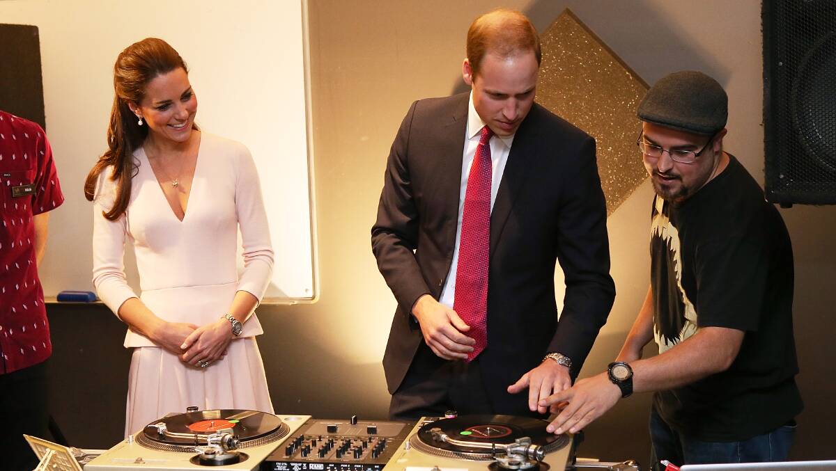 Catherine, Duchess of Cambridge looks on as Prince William, Duke of Cambridge is shown how to play on DJ decks. Photo: Getty Images