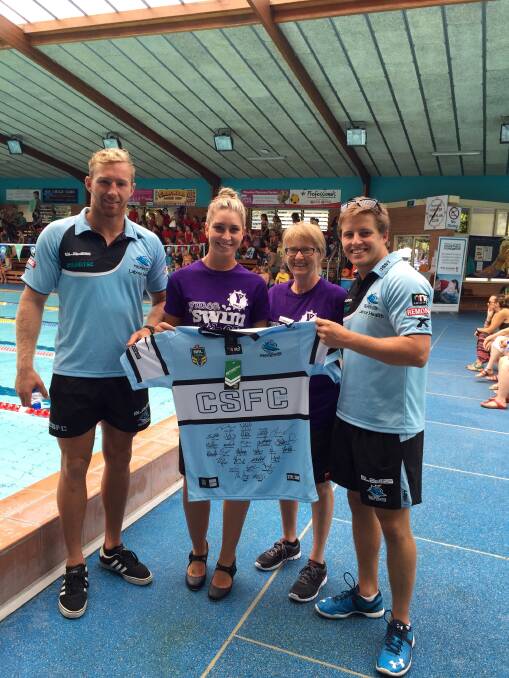 JERSEY FOR SWIMATHON: Cronulla players Matt Prior and Todd Murphy with Forster YMCA staff Ash Alcorn and Sharon Bourke. 