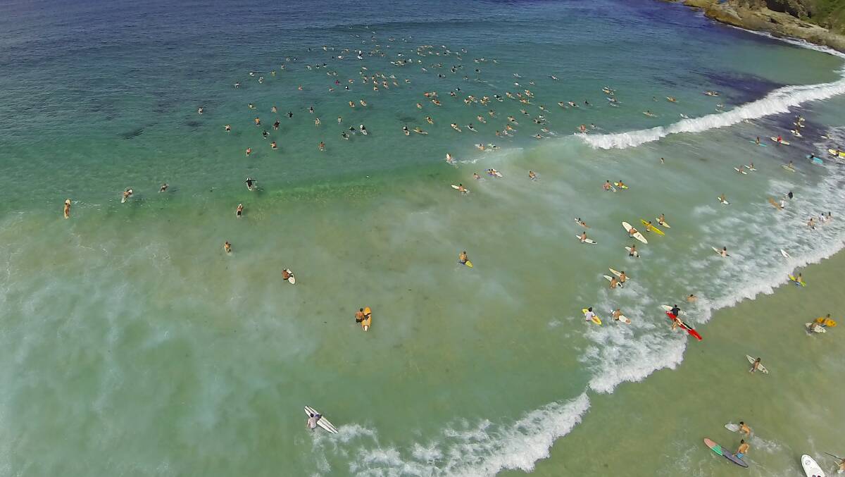 FLOATING MEMORIAL: Thousands of Toby Flew's family and friends paddle out in his memory at One Mile Beach on Tuesday March 4. Photo by East Coast Photography. 