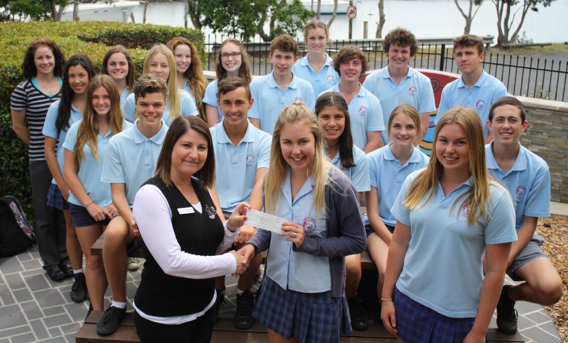 GENEROUS DONATION: Great Lakes College year 10 student Charlie Whitfield and Leah King (right) present Mid North Coast Ronald McDonald Family Retreat coordinator and community engagement coordinator Rhiannon Curtis with a $350 cheque. Students generated the money through various fundraising activities.  
