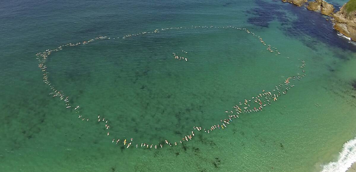 FLOATING TRIBUTE: Friends and family took part in a paddle out at the southern end of One Mile Beach on Tuesday March 4 to commemorate the ever-inspiring Toby Flew who tragically lost his 14-month battle with cancer. Photo East Coast Photography.  