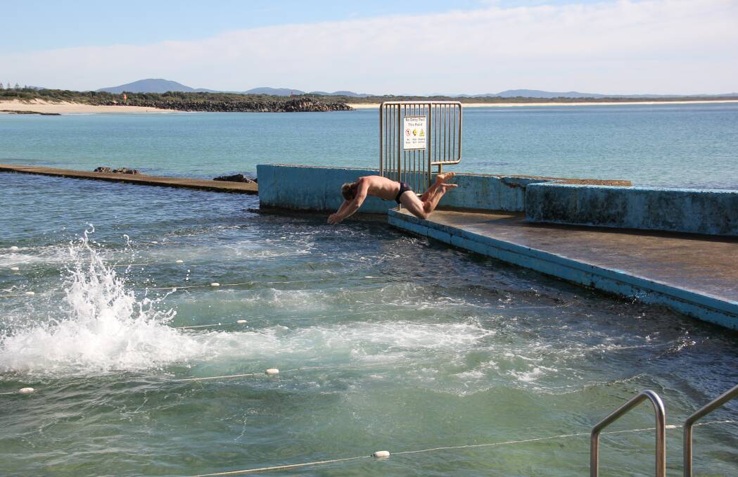 DIVE IN: Club captain Jason Berg takes flight during a club swim at the Forster Ocean Baths.  