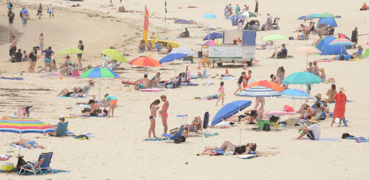 AT THE BEACH: Crowds at Forster’s Main Beach earlier this month. The Great Lakes tourism sector has experienced strong holiday trade this season thanks to repeat visitors and online marketing.  
