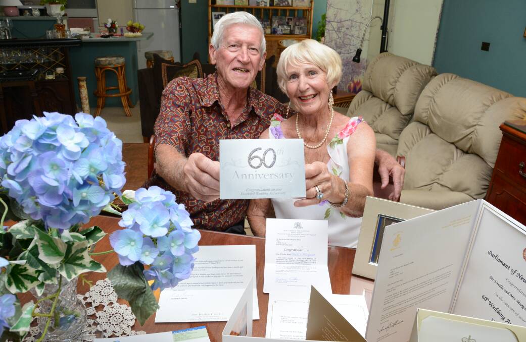 OVERWHELMED WITH RESPONSE: Nev and Marg Milne at home in Forster with all their cards and certificates from politicians and dignitaries including the Queen. Photo by Carl Muxlow. 