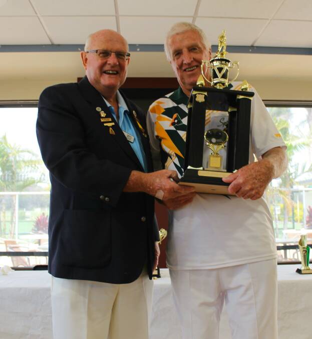 TOP HONOUR: Dennis Lawler being presented with his trophy by district president Harry Williams. 