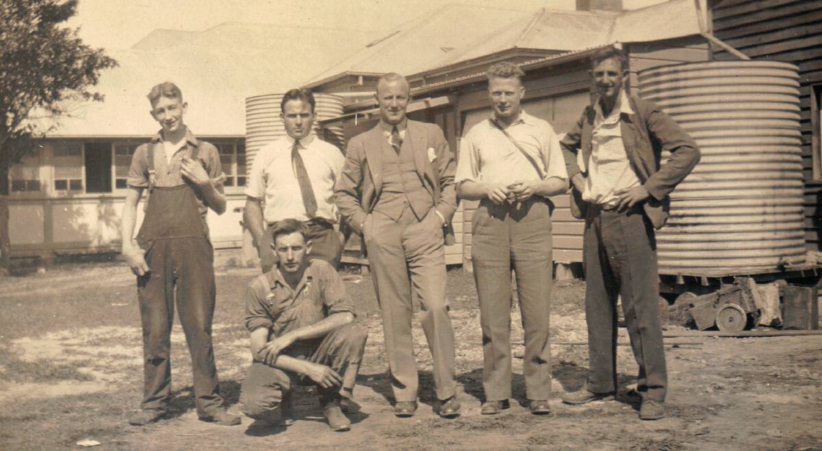 NAMES NEEDED: This week’s mystery photo of a group of men is believed to be taken at Nabiac circa 1950. “Dick Newell and H. Wallis” are the only names handwritten on the back of the photo. 
