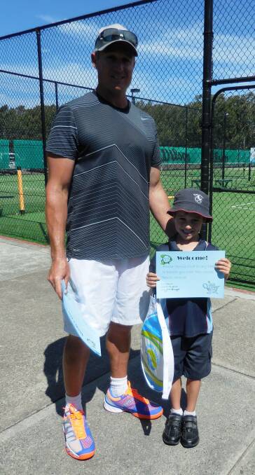 READY TO PLAY: Coach Jaime McDonagh with his son Finn.  The Forster Tennis Club initiative will see kindergarten children from Forster Public School receive a free tennis racquet and coaching session.        
