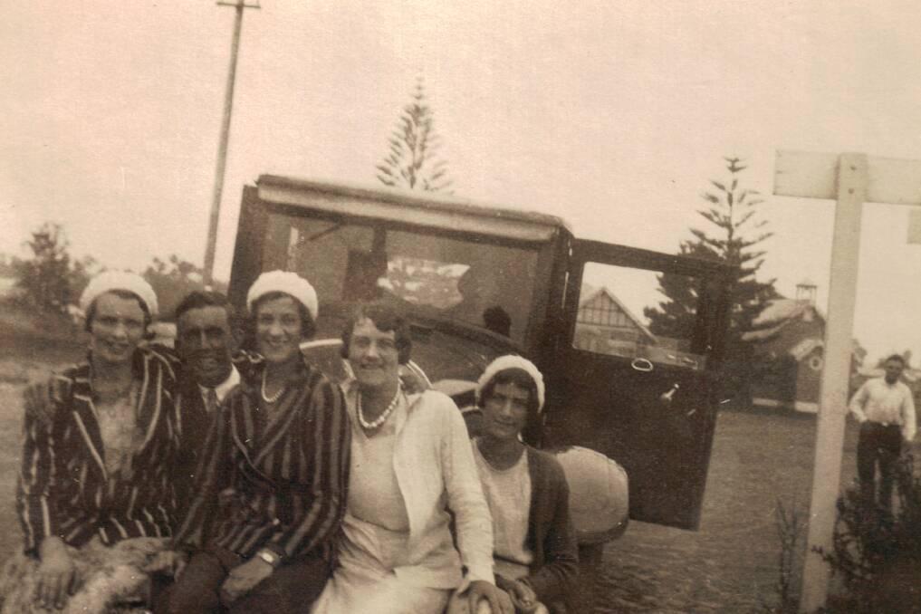 IN FLOOD: This photo, taken near the Tuncurry ferry approach, shows a group of four unidentified women and a man possibly waiting for the vehicular ferry. 
 