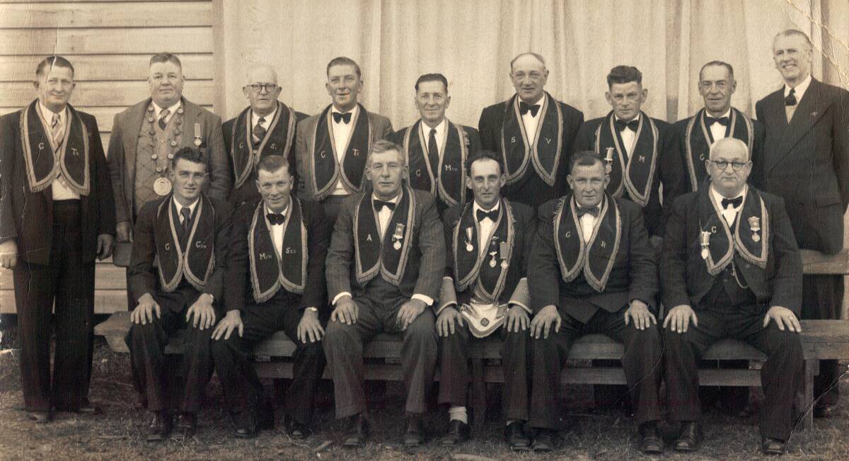 JUST TWO NAMES: Only two names have been documented with this  portrait of members of the Wallis Lake Lodge circa 1950.  They are Lester Brown pictured second from left in front row and Bert (Pop) Dent pictured sixth from left in the front row.  
 