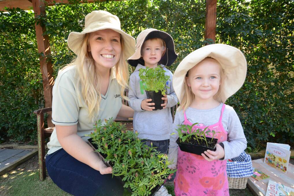 NURTURING GROWTH: Lillipilly Preschool’s Casey Kent with Preston Robertson and Ruby Howard.  
  