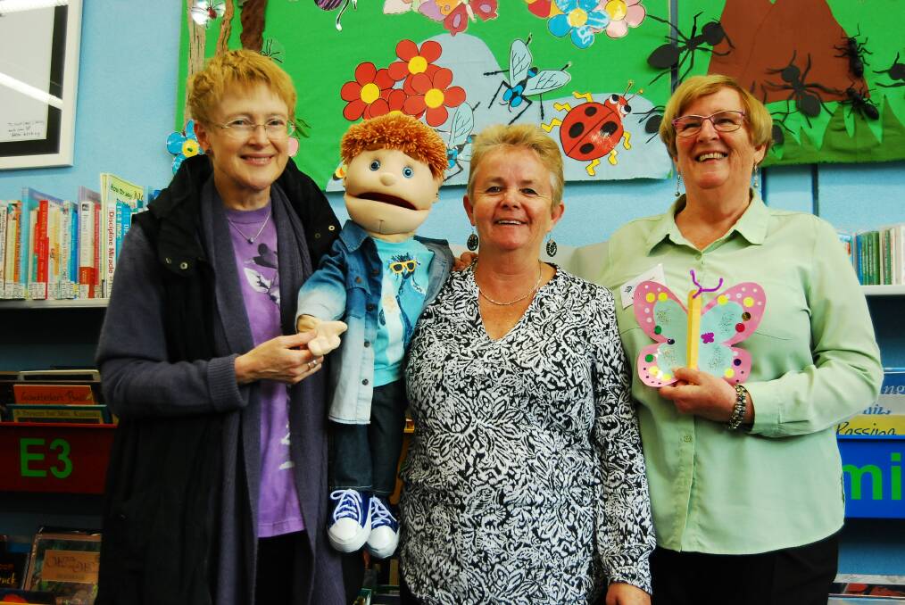 KIDS LOVE ANDY: The much-loved puppet with his ‘support group’ Amanda Stewart, Rowena Chater and Helen Duggan  after a story session at the library. 