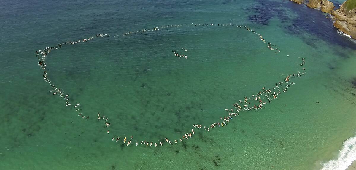FLOATING MEMORIAL: the paddle out held for the late Toby Flew at One Mile Beach on Tuesday March 4. Photo by East Coast Photography. 
