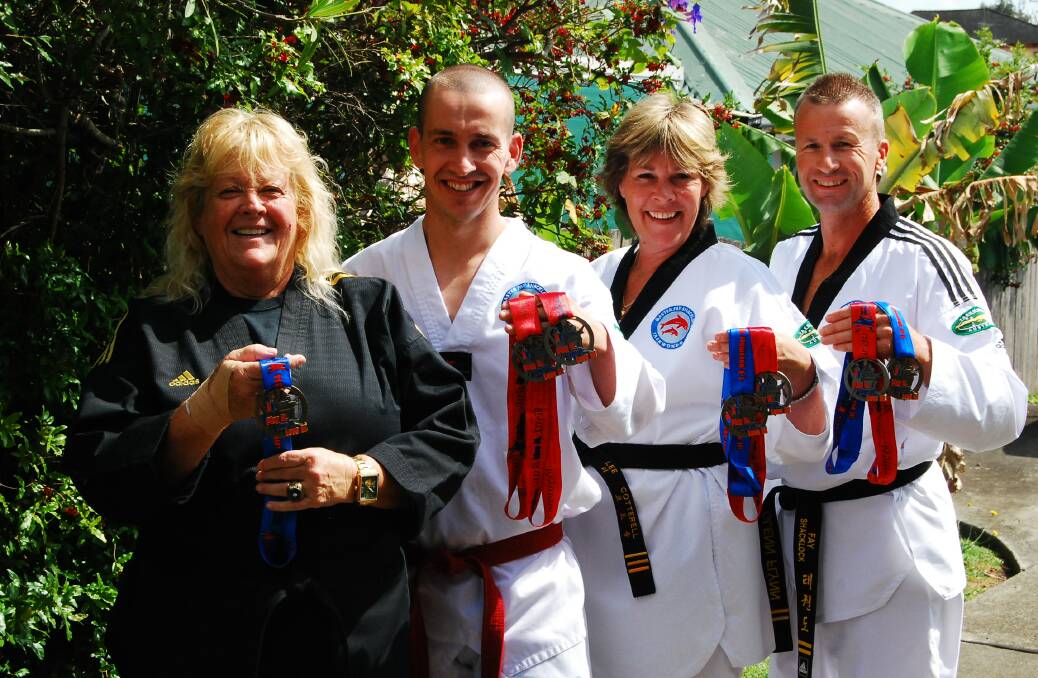 TRIUMPHANT: Tae Kwon Do master Fay Shacklock and her masterful A-team: Scott Gabriel, Lee Cotterell, and Glenn Flynn with their medals from the Pan Pacific Masters Games. 
