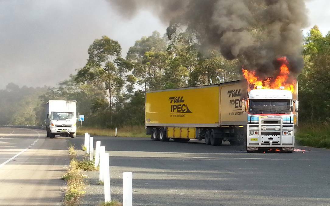 HIGHWAY HAVOC: The Pacific Highway was closed in both directions about ten kilometres south of Coolongolook on Friday when a semi-trailer (pictured) caught on fire. Photo by Peter Brabant.  

