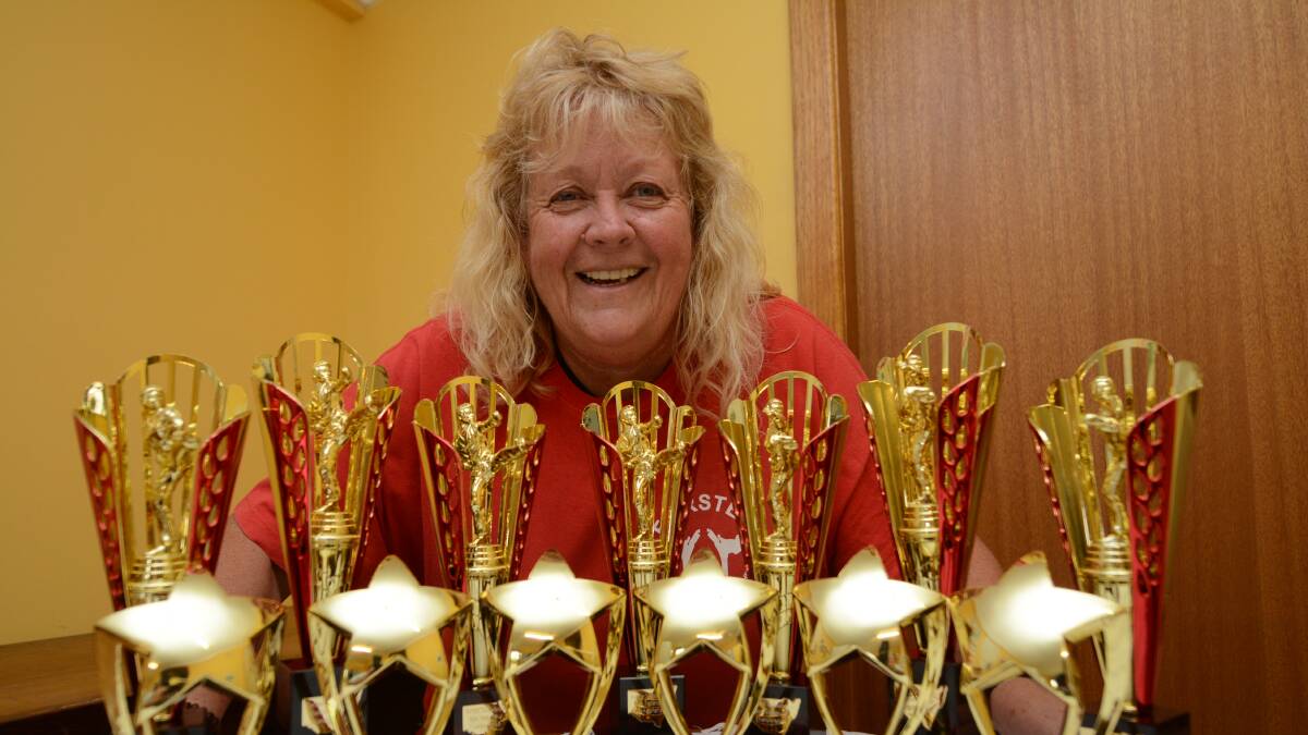 BEHOLD THE TROPHIES: Faye Shacklock gets ready to host this year’s Taekwondo State Development Invitational Championship. She said whilst gradings are generally used to reward improving skills, trophies are always appreciated.
