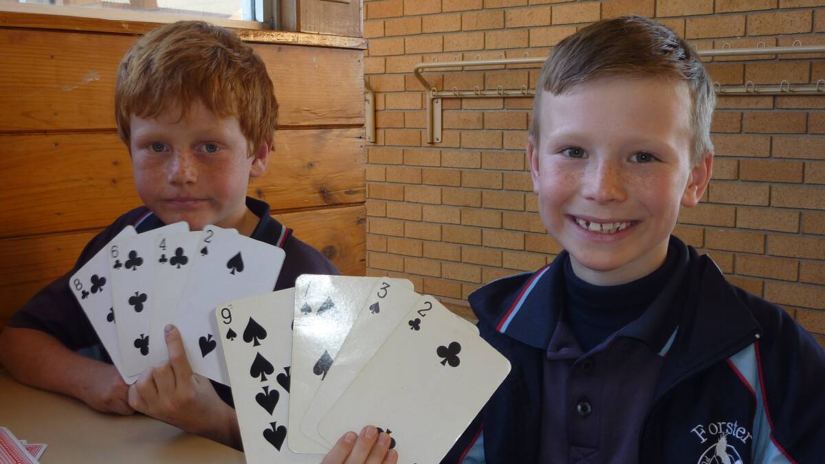 THINKING BIG: Thomas Kennedy and Tom Williams using cards to make the biggest number possible.