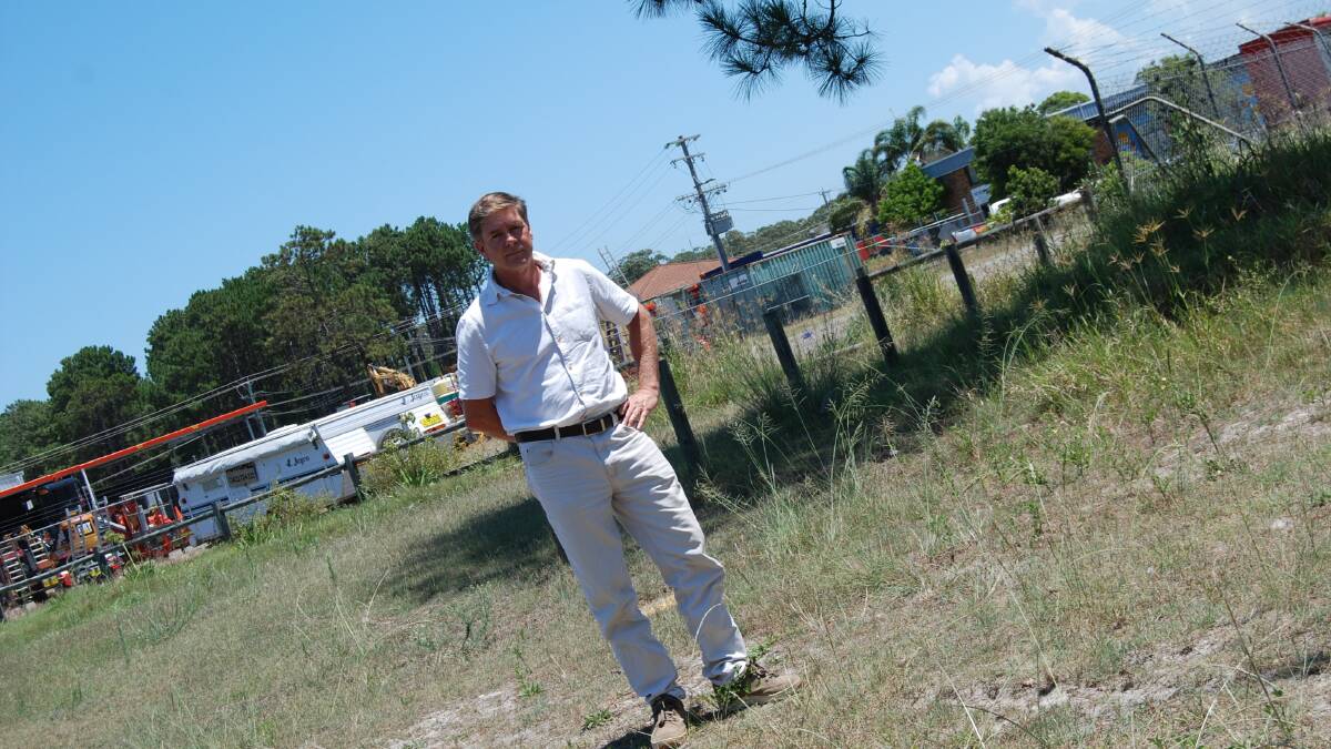 CAPTURED MARKET AND INLFLATED PRICES: Paul van Drunen at the proposed site for a new Woolworths petrol station.  He forsees traffic problems and no discounted fuel.