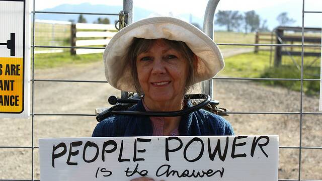 Sharyn Munro, aged 66,  is secured to an AGL gate in GLoucester by her neck with a metal D-shape lock. 