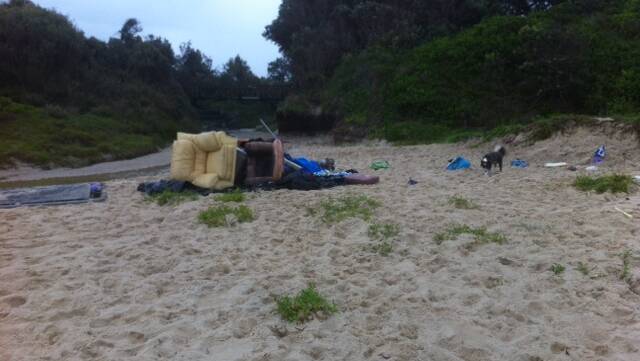 LEFT BEHIND: A reader sent in this photo of rubbish including a lounge, flags and a trampoline left on the northern end of One Mile Beach after Australia Day celebrations on Monday. 
