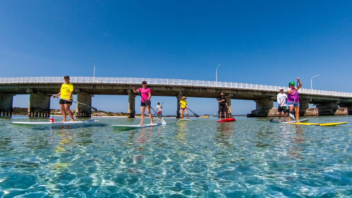 CORE STRENGTH: Stand Up Paddle board instructor Charne Musgrove (in the middle in pink) leads a class to stand up paddling success. Photo by Adam Scard.